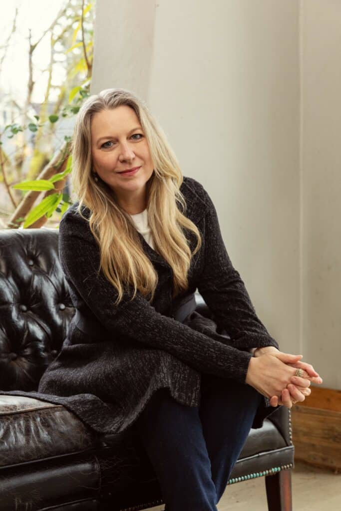 Author Cheryl Strayed sitting on a couch