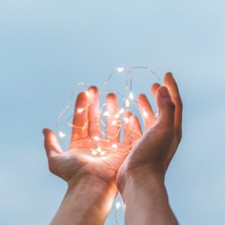 person holding string lights