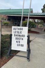 Sign that says: Author Leslie Barnard Booth 4/3 10:00
